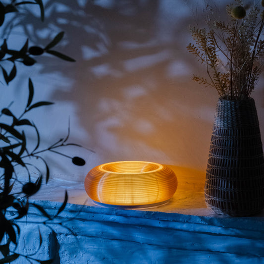 3D printed Creamsicle donut lamp on a nightstand