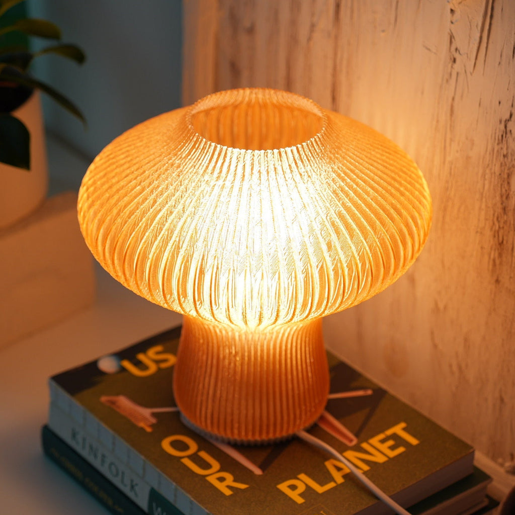 Close-up of the fluted texture on the NAMU amber table lamp, lit from within