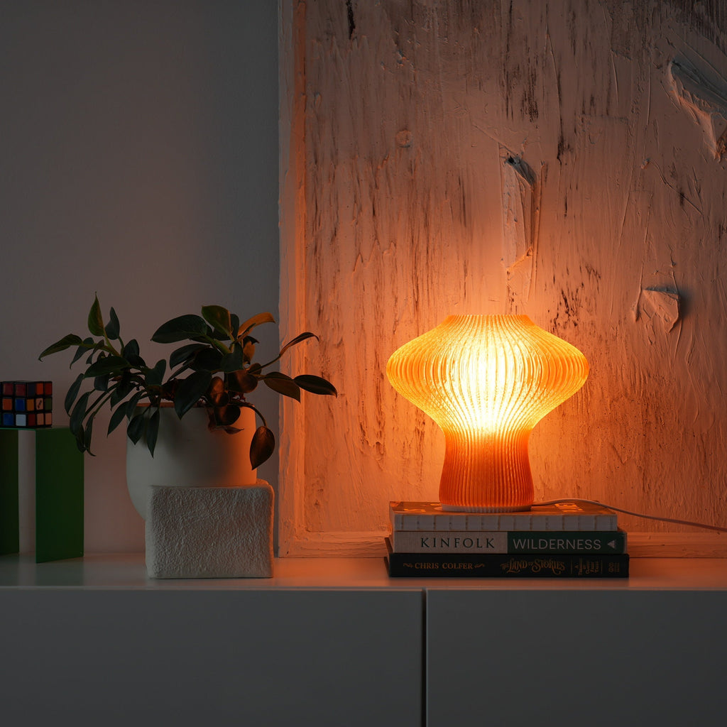 NAMU amber table lamp on a white sideboard in a dim room