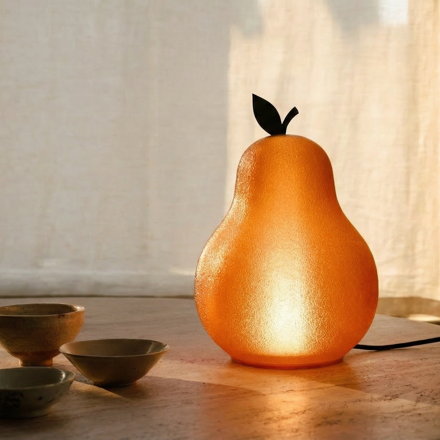 Pear-shaped lamp on a wooden surface with soft lighting