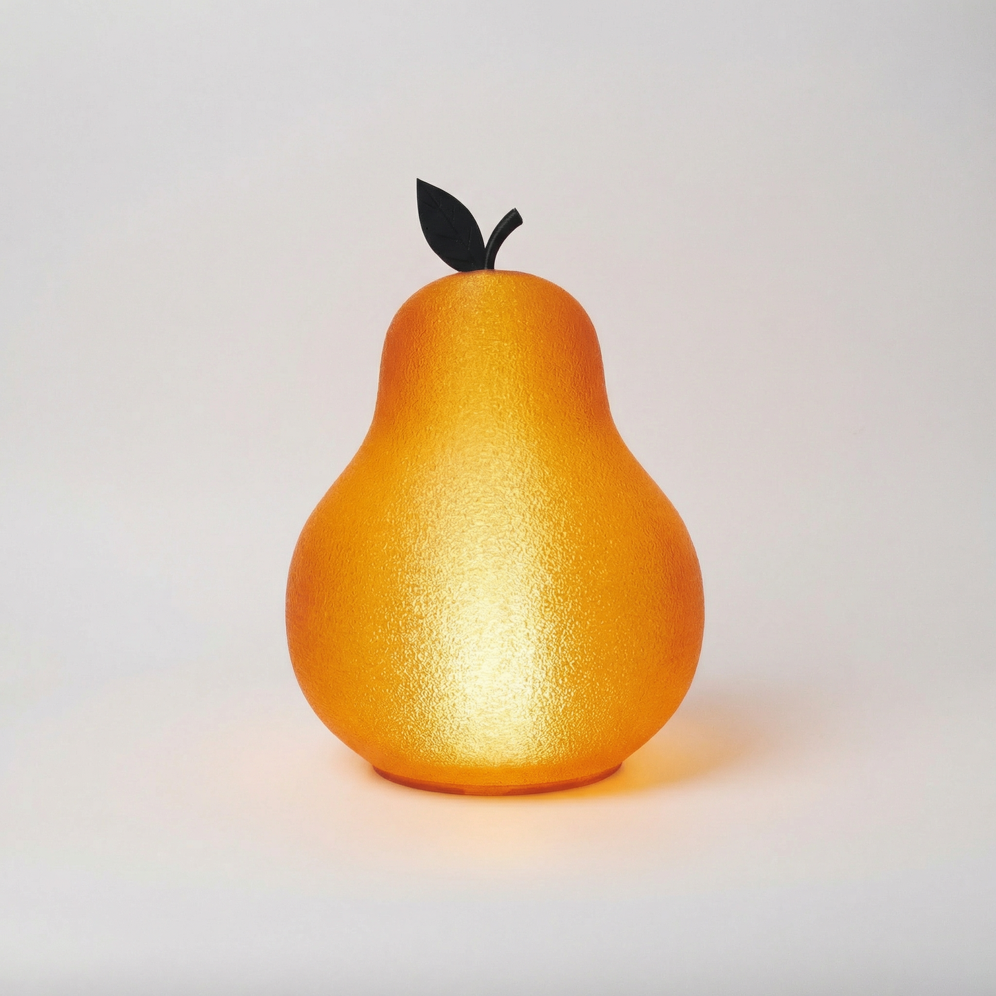 Pear-shaped lamp with a dark green leaf on a light white background